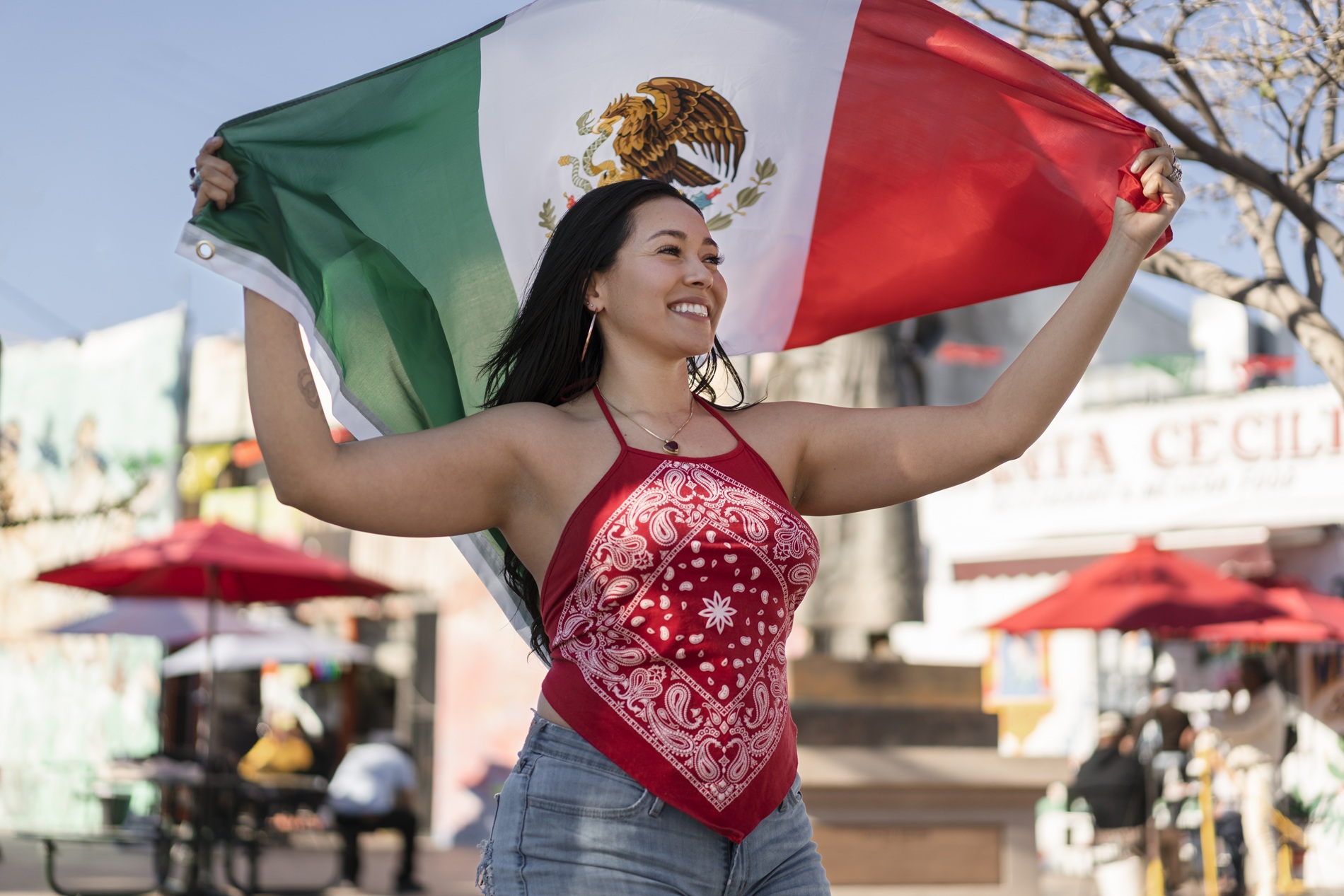 woman-holding-mexican-flag-street